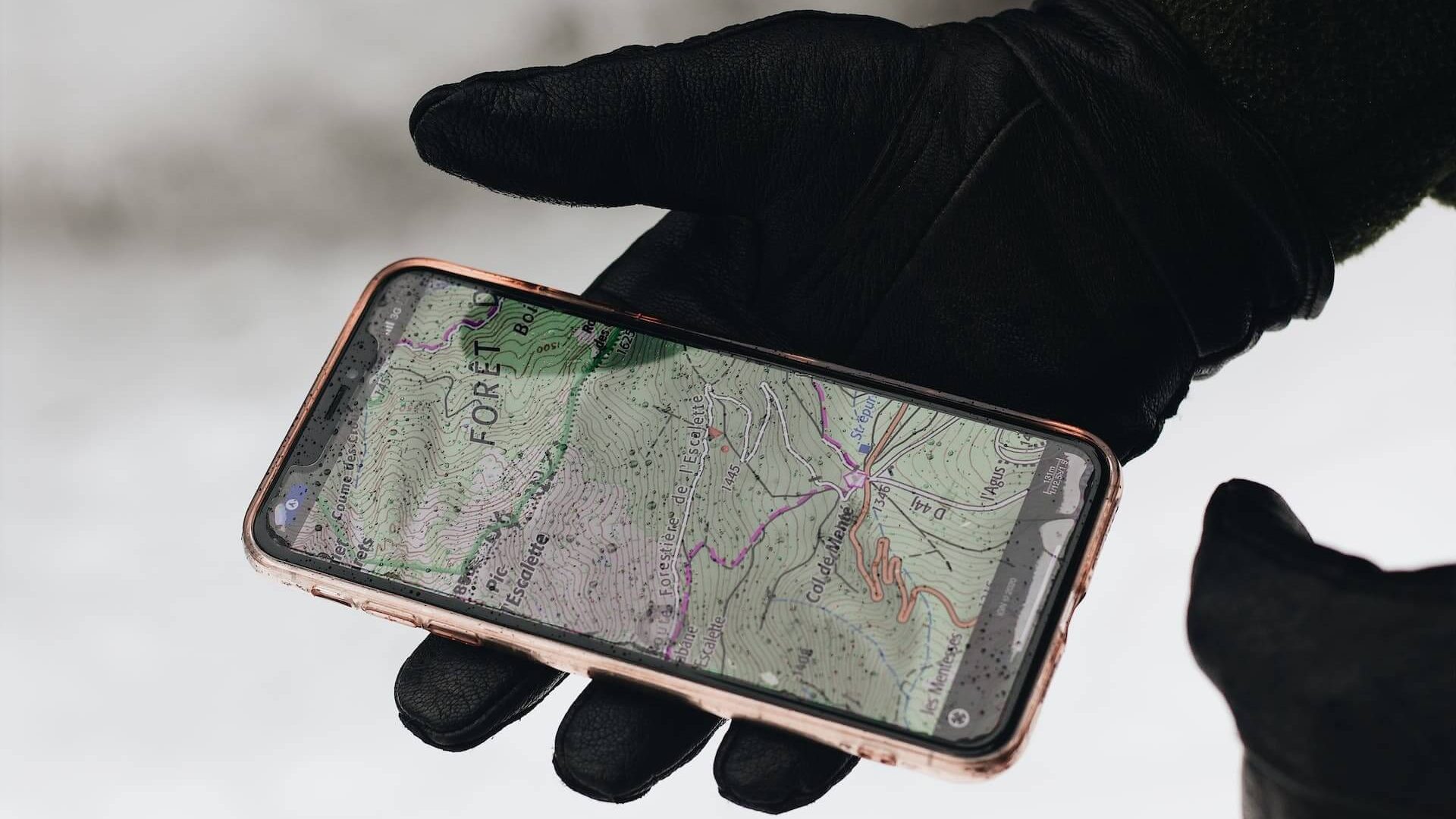 Smartphone displaying a phone number tracker app, tracking the location of a specific number