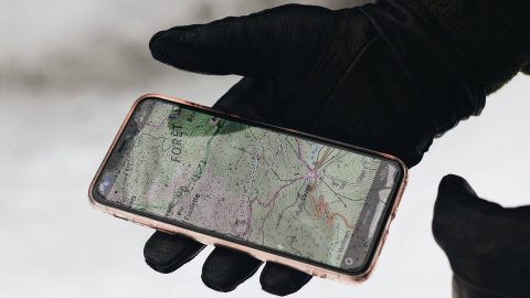 Smartphone displaying a phone number tracker app, tracking the location of a specific number