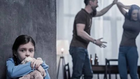wo parents heatedly disputing over child custody in front of a saddened child