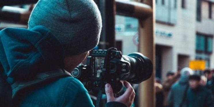 Private investigator covertly snapping photos of a man believed to be cheating.