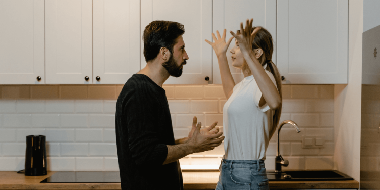 A couple engaged in a heated argument, with expressions of frustration and distress