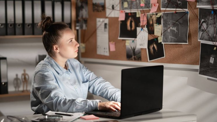Person reviewing private investigation training material in a Sydney office