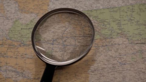 Private investigator in Brisbane reviewing surveillance photos related to an infidelity case