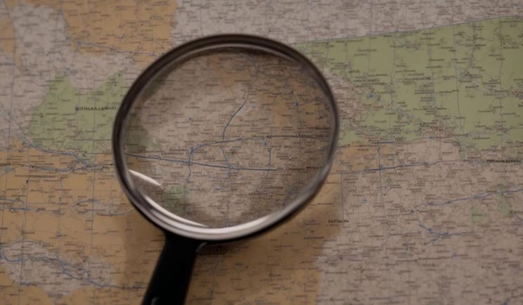 Private investigator in Brisbane reviewing surveillance photos related to an infidelity case