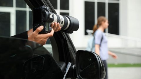 Private investigator taking photos