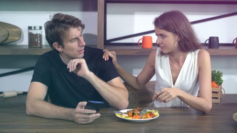 Couple having a tense conversation during a meal